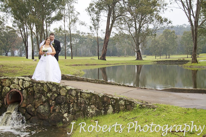 Bride and groom on a bridge at Riverside Oaks Golf Course - wedding photography sydney